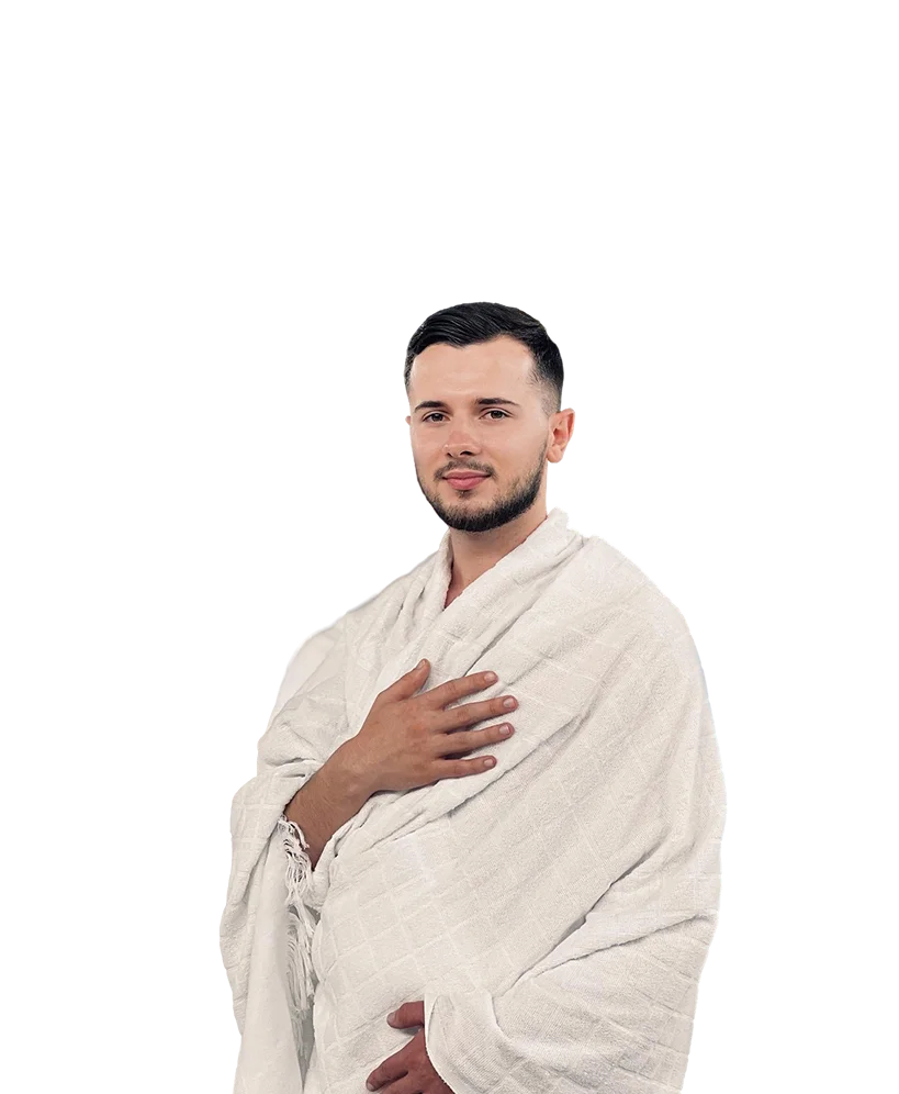 Young man in white Ihram clothing standing with hand on chest, representing Hajj and Umrah pilgrim